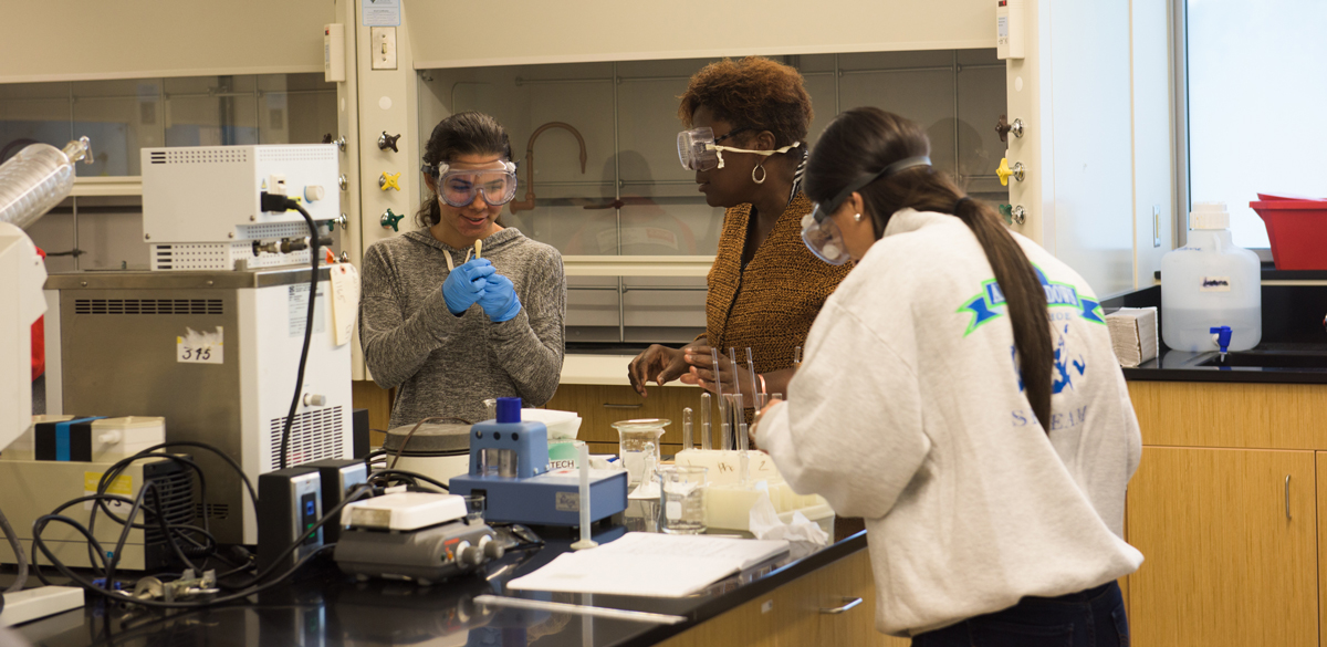 professor and students in lab; SCSU Academic Science and Laboratory building