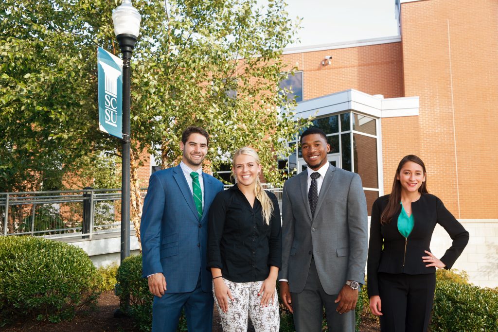[From left] Students Luke Velez, Brooke Davis and Lyman DePriest interned with Deloitte over the summer, while student Yenny Bayas completed an earlier internship during the busy tax season.