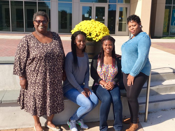Four CARE leaders in front of SCSU Buley Library