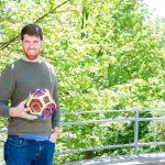 man holding math object