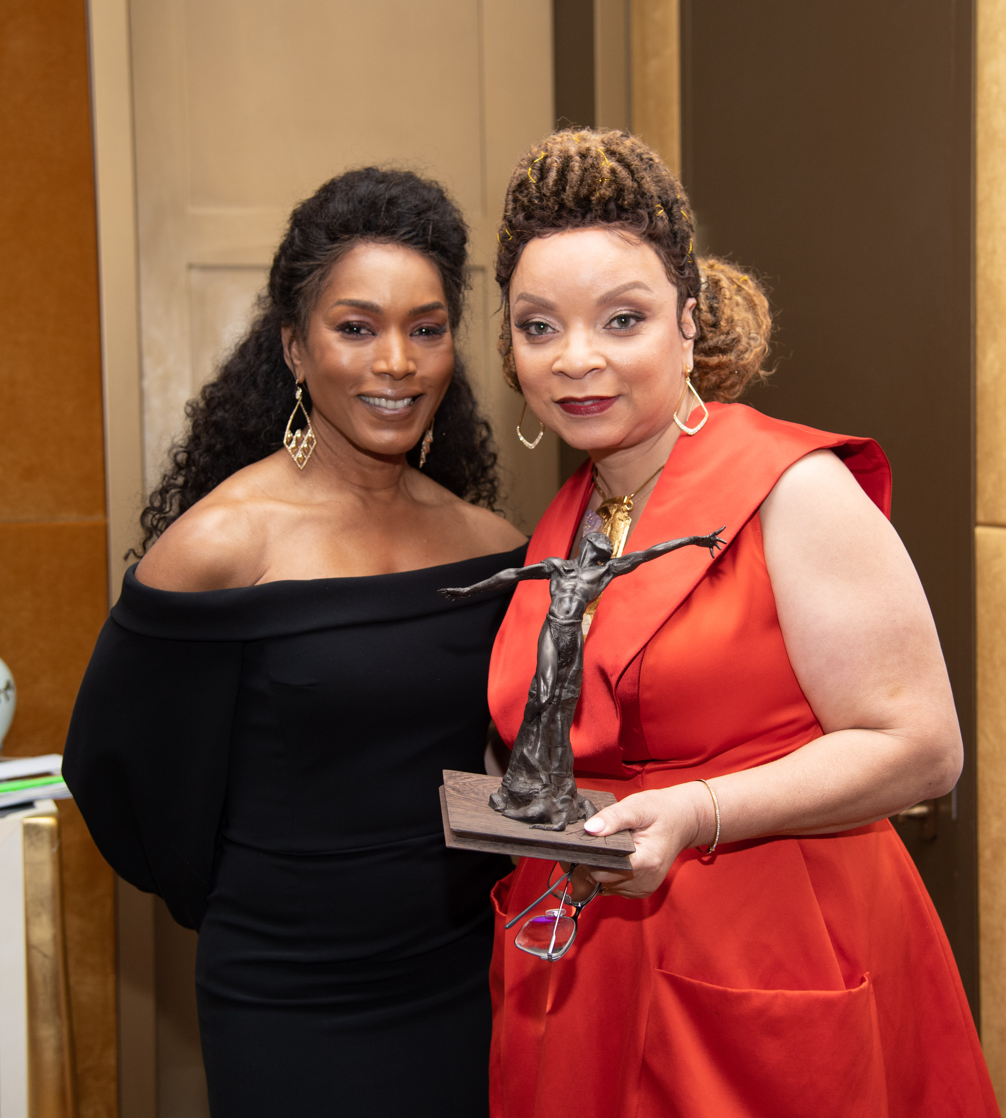 Actor Angela Bassett with Ruth E. Carter, holding the award statuette designed by Guest