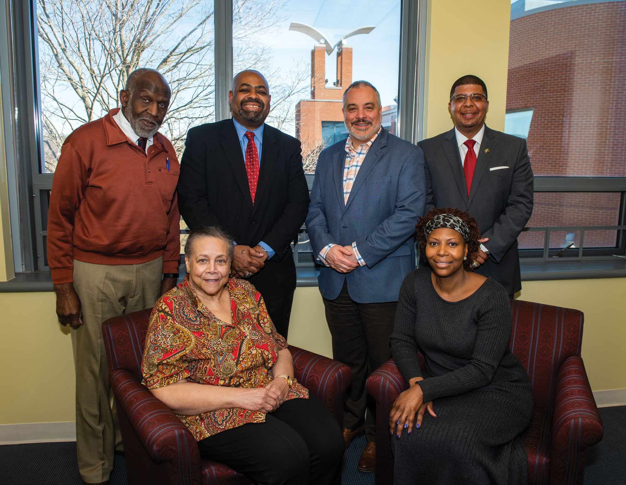 Several alumni of the Black Student Union (BSU) gather to formally establish the Barbara Matthews Endowed Scholarship, named in honor of the longtime adviser of the BSU. [Seated from left] Matthews and Michele Helms, ’92, an ESL teacher. [Standing from left] James Barber, ’64, M.S. ’79, Southern’s director of community engagement; Attorney Michael Jefferson, ’86; President Joe Bertolino; and Kermit Carolina, ’94, M.S. ’03, supervisor of youth development and engagement with New Haven Public Schools.