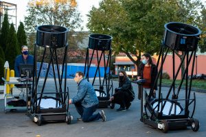 Physics Professor Elliott Horch and students use portable telescopes outside