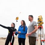 Derek Faulkner and two female students perform research on a Connecticut beach