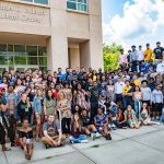 a large group of students standing on the steps of the Adanti Student Center
