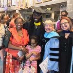 Tai Olasanoye with his family and faculty members at his graduation
