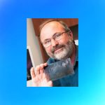 Professor holding celluloid film strip