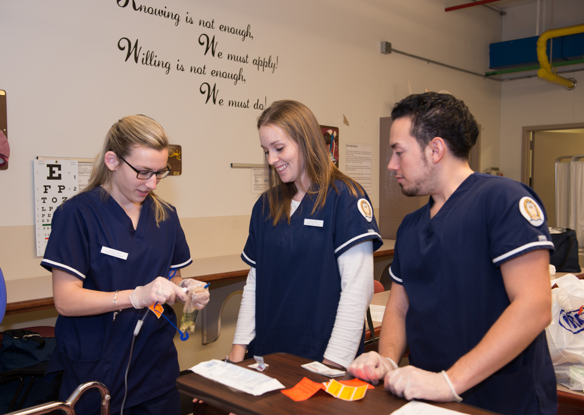 Three SCSU nursing students working together in nursing lab