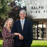 Esther Friesner-Stutzman and Walter Stutzman stand in front of Earl Hall on the SCSU campus