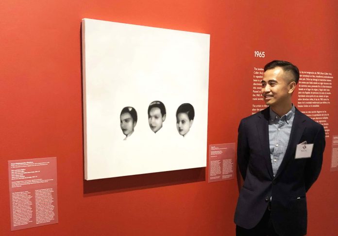 Thuan Vu with one of his paintings