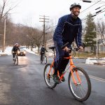 a few people ride bicycles in new haven