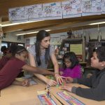 a student teacher works with her students in the classroom