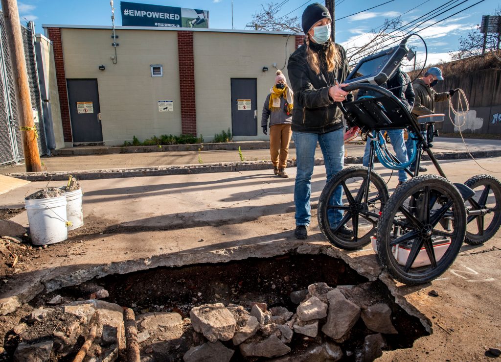 Debbie Surabian, a soil scientist with the State of Connecticut, uses ground-penetrating radar to collect data.