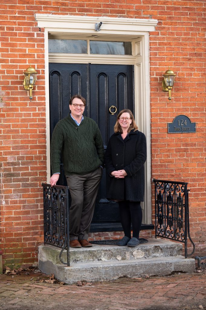 SCSU alumni Laura Macaluso, ’94, and Jeffrey Nichols, ’96, sitting on steps in front of their home in Boiling Springs, Penn.