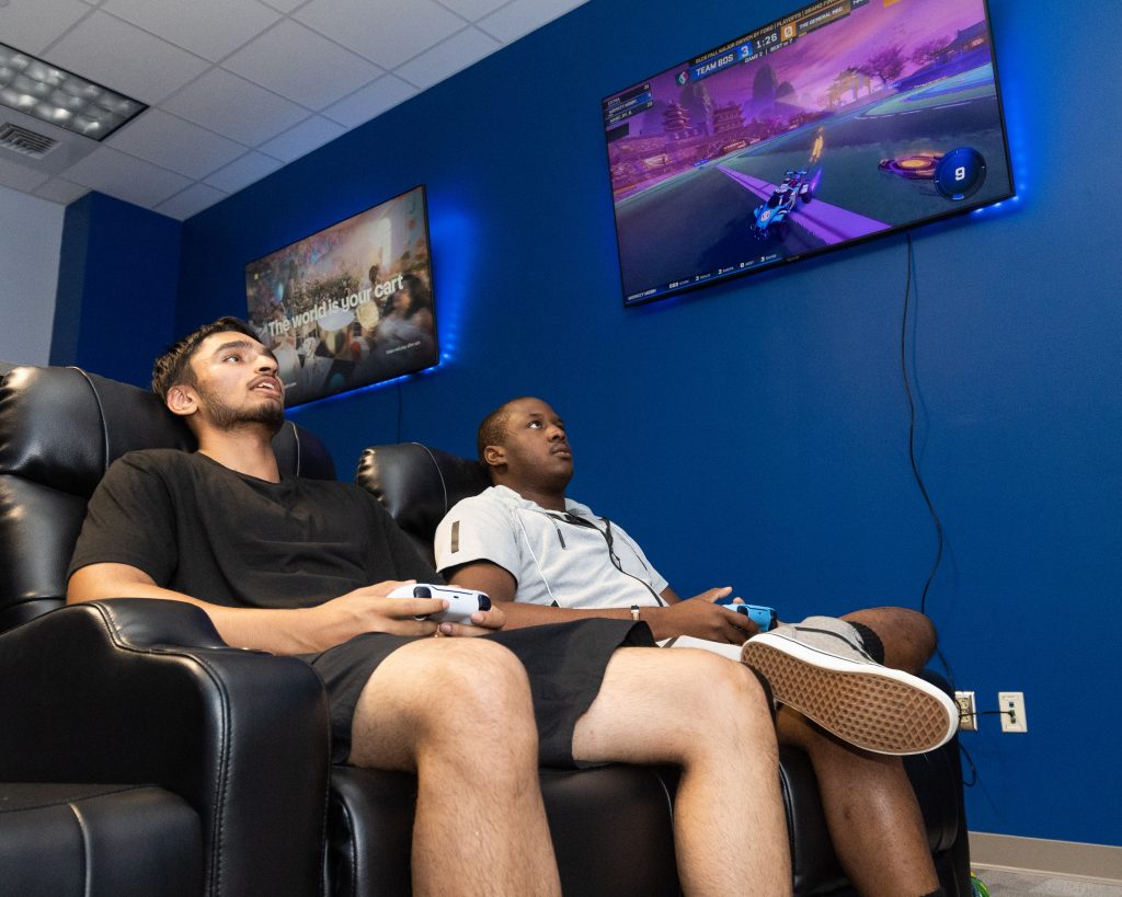 Two students playing video games in new esports lounge
