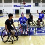 Wheelchair basketball on basketball court.