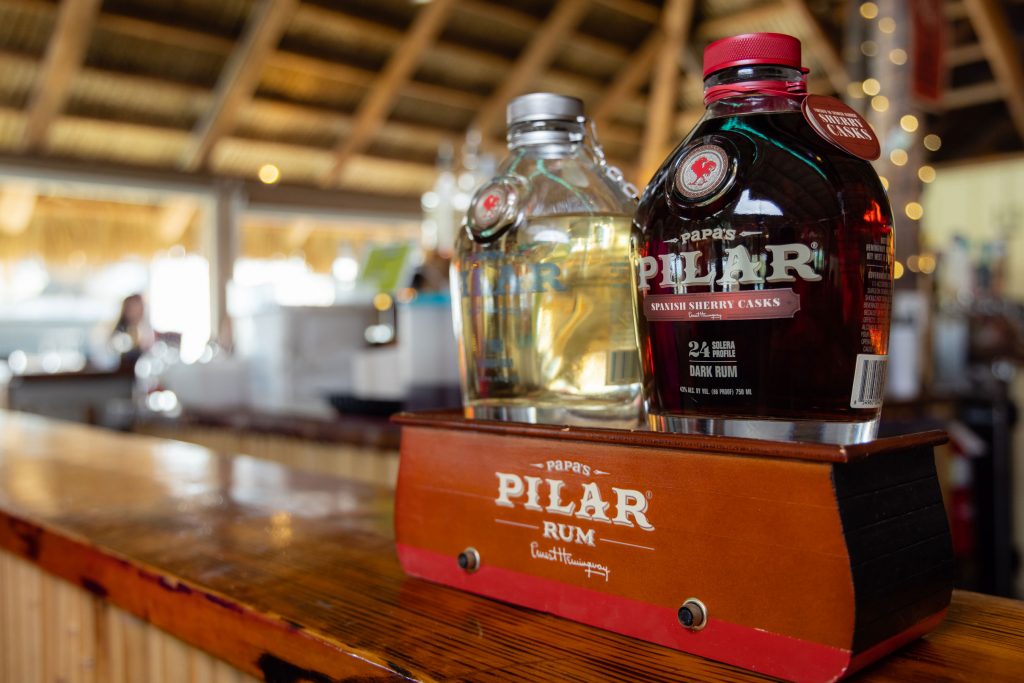 SCSU alum Nick Doyle, ’90, showing bottles of Papa’s Pilar Rum