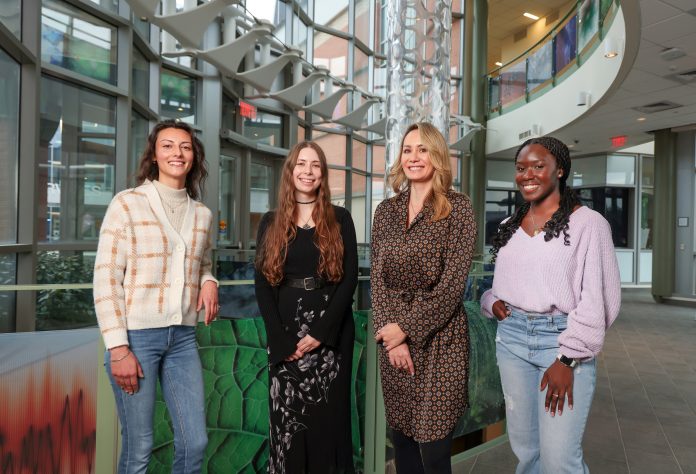 Four women posing in Southern's science building.
