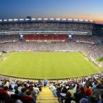 a football stadium with fans in the foreground