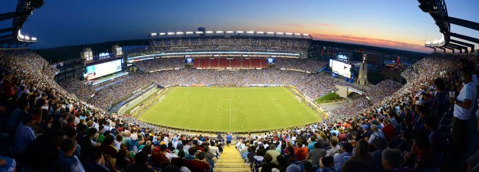 a football stadium with fans in the foreground