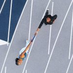 Photographed on Southern's track, the Olympic champion takes the baton from her mother — Dawn Stanton, '90, M.S. '97, the director of University Access Programs at Southern