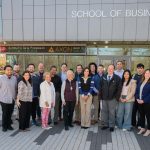 a group of people from the SCSU School of Business and the Regional Water Authority stand in front of the School of Business building