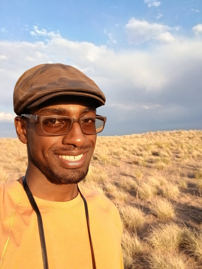 Ade_Ben-Salahuddin stands in a stark plain in Arizona.