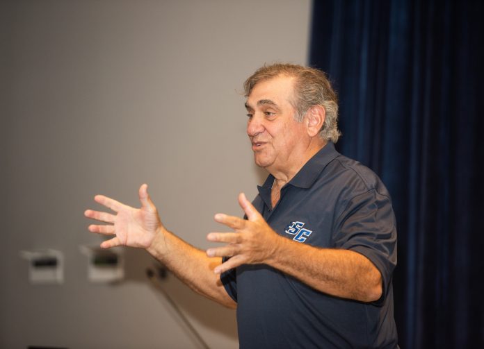 Dan Lauria speaking to a group of students in a theater.